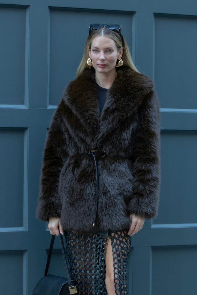 Sophisticated winter fashion with fur coat and modern accessories in NYC.