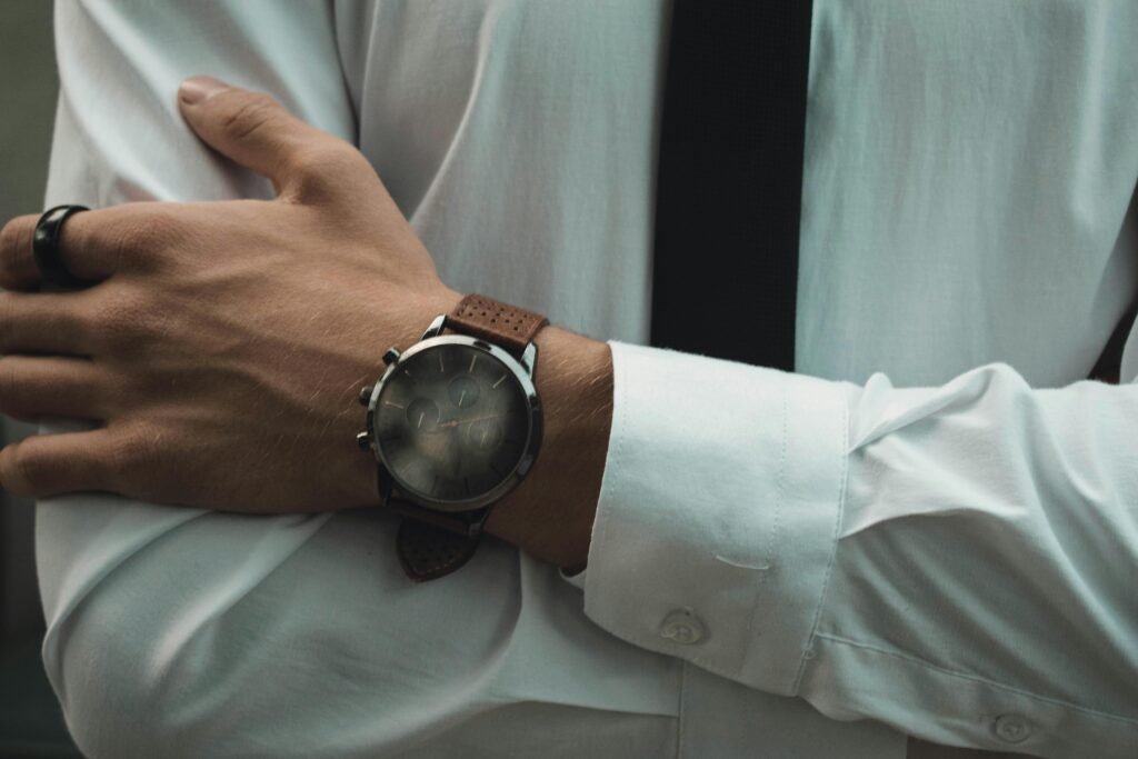 Professional close-up of a wristwatch adorning a businessman's arm in formal attire.