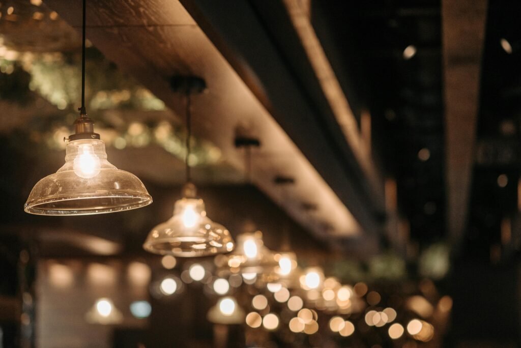 Warm and cozy indoor atmosphere with vintage hanging lamps and soft bokeh lighting.